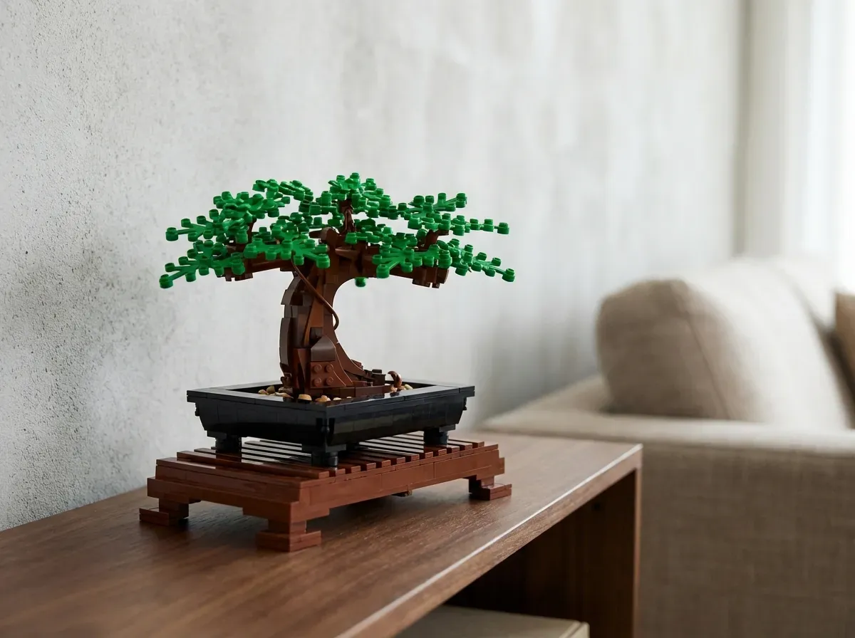 Well-lit builder's workspace with LEGO Bonsai Tree in progress, featuring organized sorting trays, magnifying glass, and ergo
