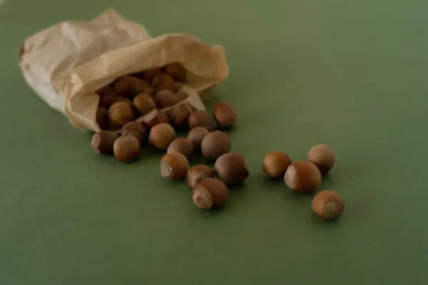 Various bonsai seeds in glass containers and labeled packets displaying different seed sizes and colors for growing bonsai fr
